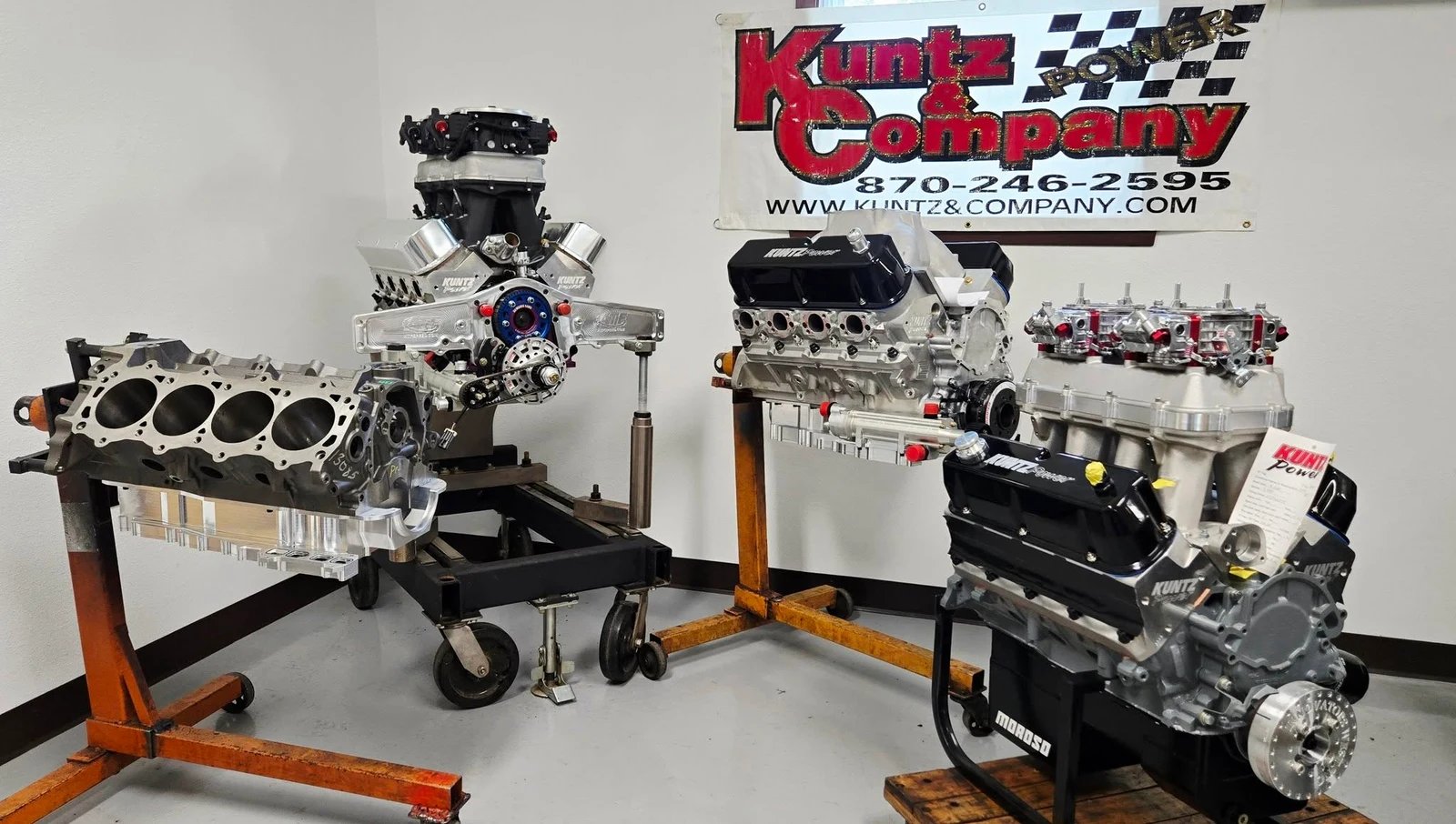 Engine builds and machined components displayed beneath Kuntz and Company signage