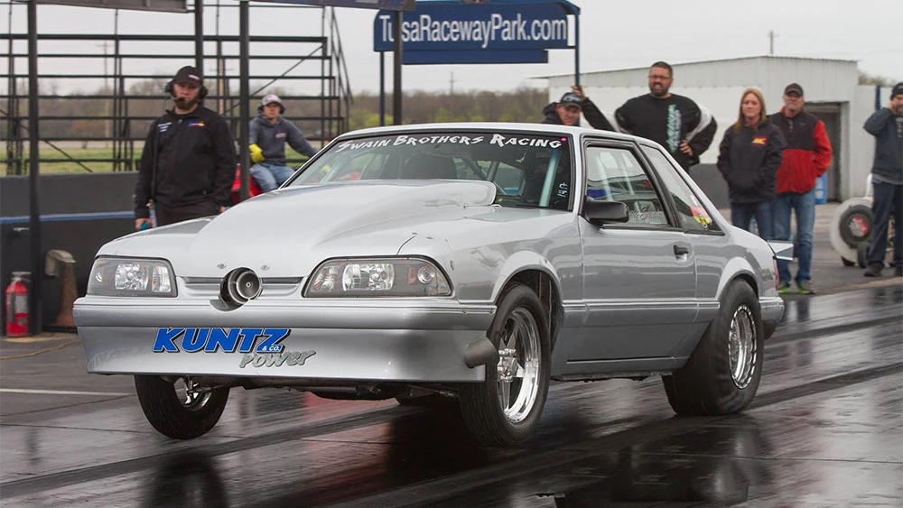 Silver turbo Mustang at the race track